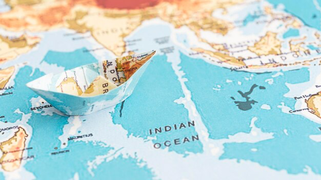 Paper boat on the world map